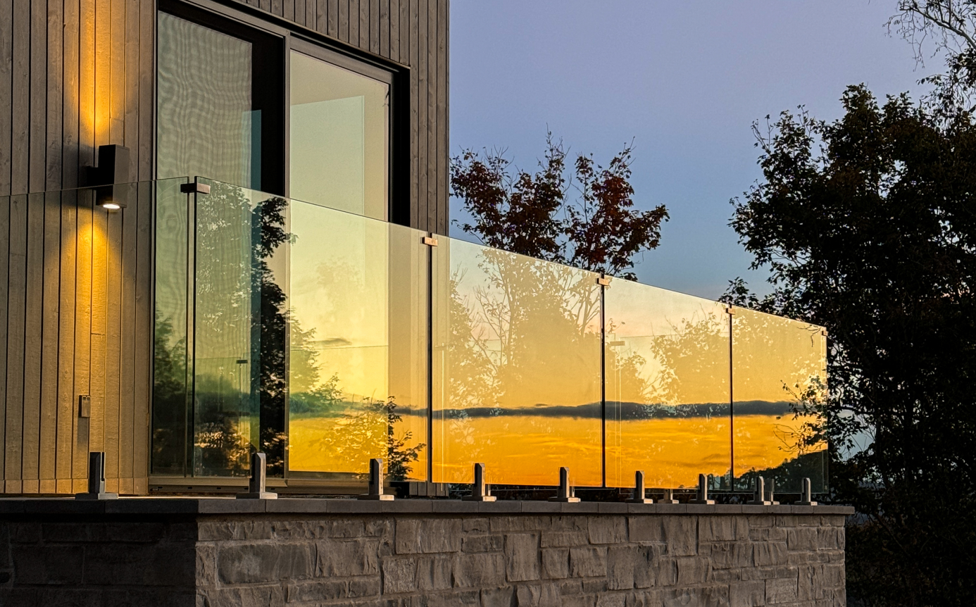 Glass railing installed on a balcony at sunset